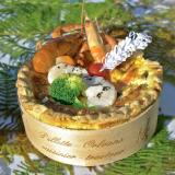 Seafood pie cooked in a glued-wood ring